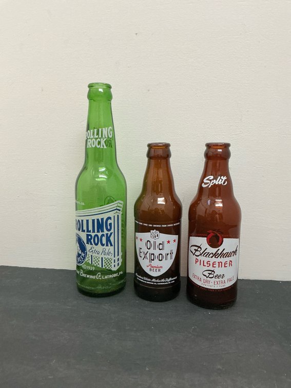 3 glass beer bottles with applied color labels