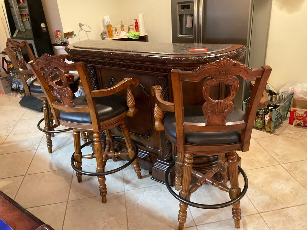 Carved wood home bar with stone top & 3 swivel barstools - Basement Living & Bar Area