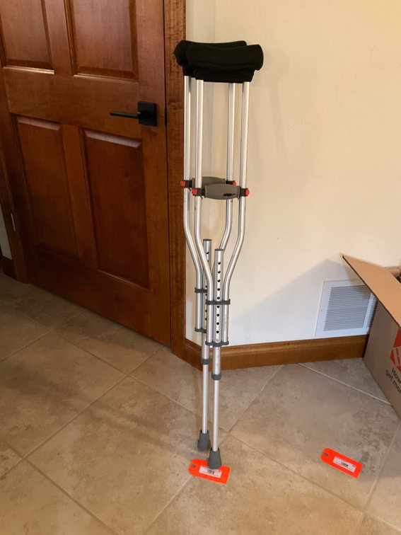 Pair of adjustable aluminum crutches with padded covers - Basement Living & Bar Area