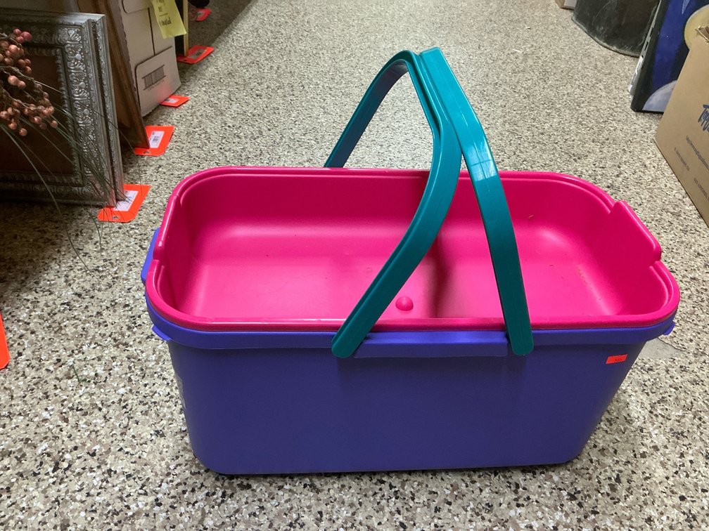 Plastic caddy with assorted VHS tapes & rustic decor