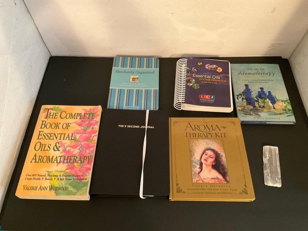 Grouping of 6 wellness & aromatherapy books & selenite bar - Basement Living & Bar Area