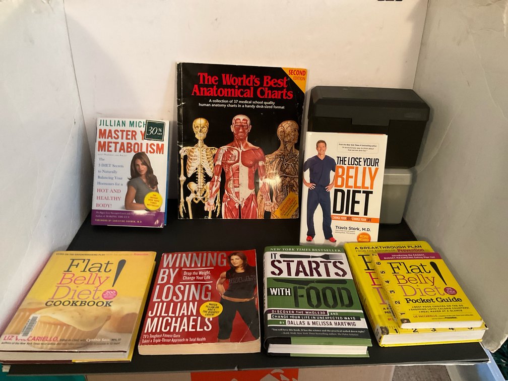 Grouping of diet, fitness & anatomy books - Basement Living & Bar Area