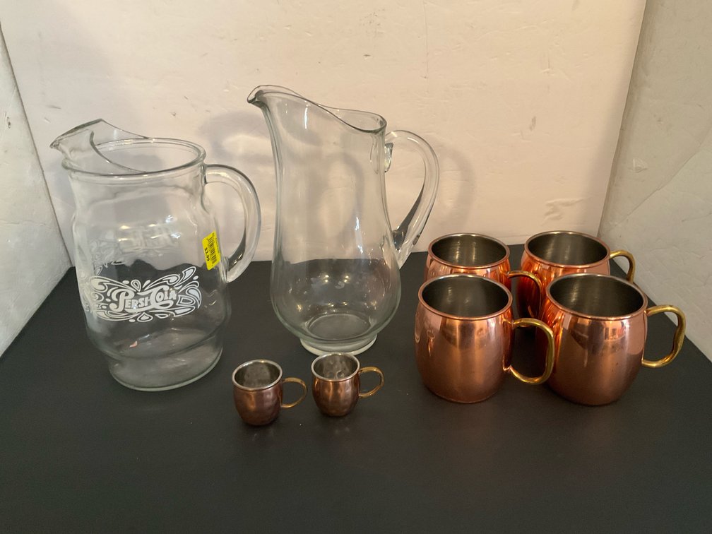 2 glass pitchers & 6 copper-finished mugs - Basement Living & Bar Area