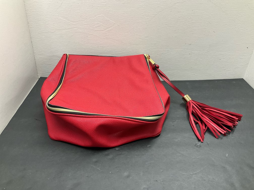 Estée Lauder red pebbled bag with tassel zipper pull