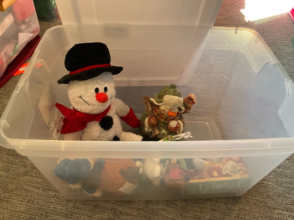 Assorted holiday decor, plush figures & storage tote - Basement Living & Bar Area