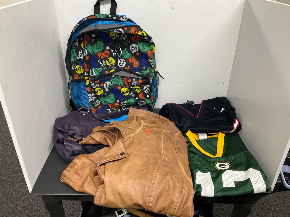 Assorted sports jerseys, jacket, backpack & handbag