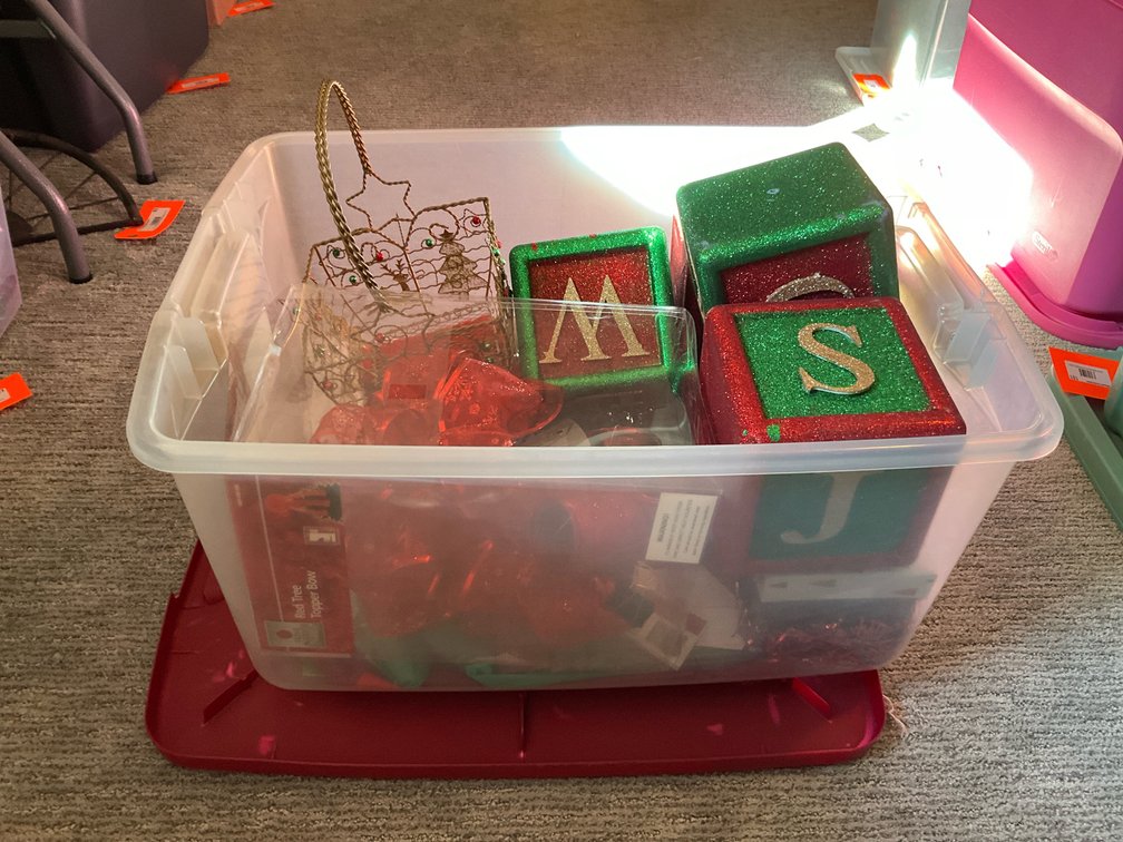 Assorted Christmas decor & supplies with storage tote - Basement Living & Bar Area