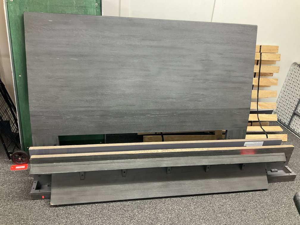 Disassembled gray wood-finish bed frame 74”