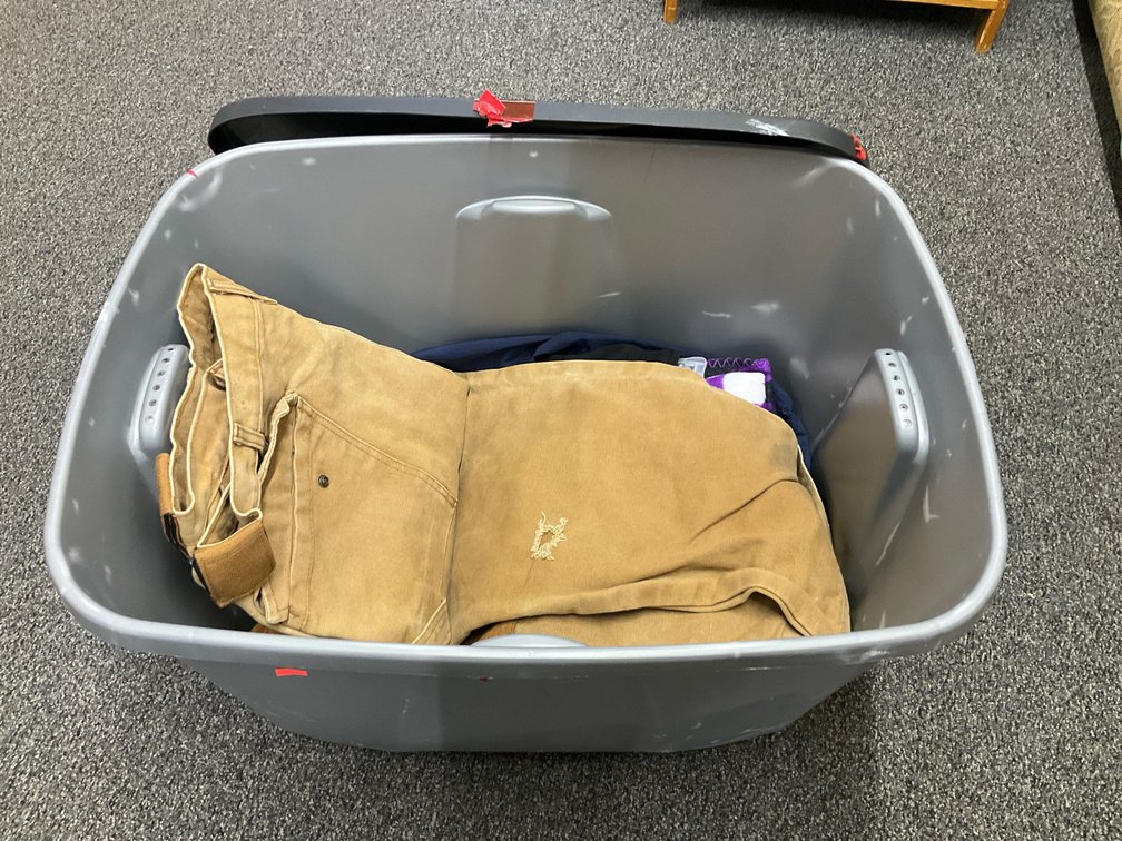 Storage tote with assorted clothing & fleece blanket