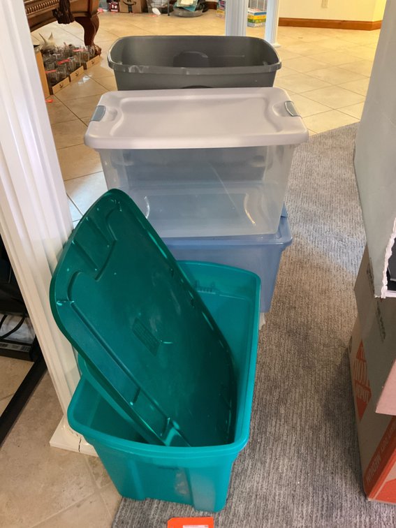 Grouping of plastic storage totes - Basement Living & Bar Area