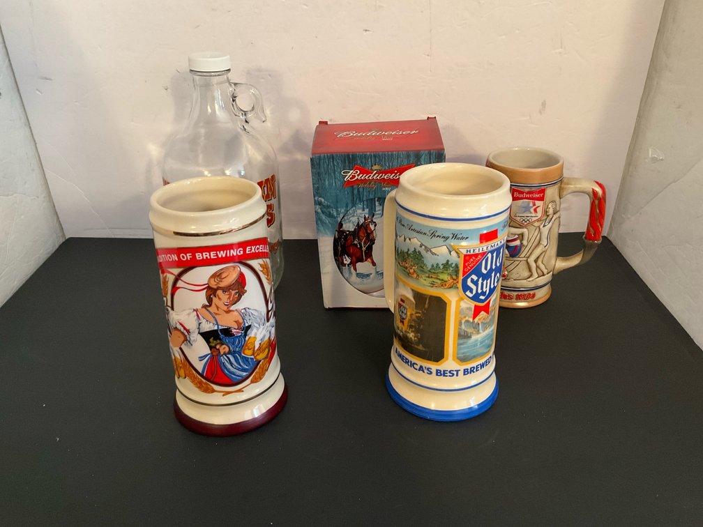 Grouping of 4 ceramic beer steins & glass growler - Basement Living & Bar Area
