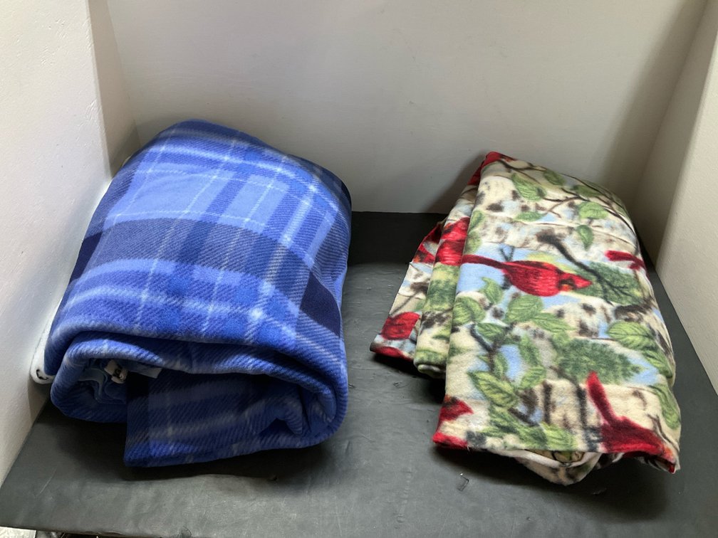 2 fleece blankets with cardinal & blue plaid patterns