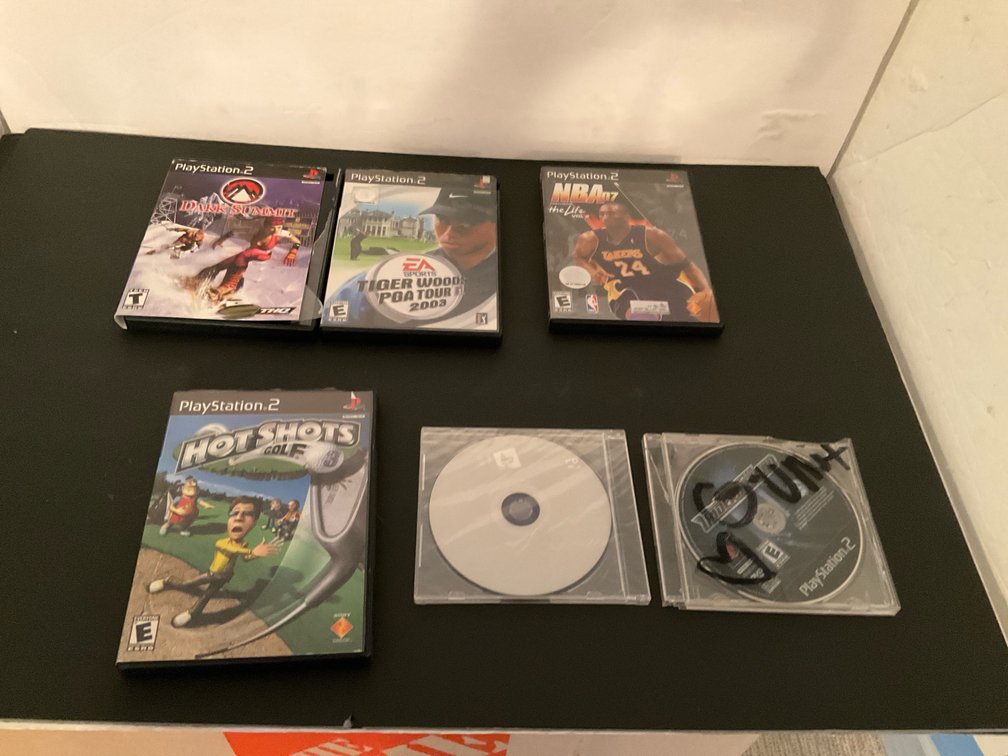Grouping of PlayStation video games & discs - Basement Living & Bar Area