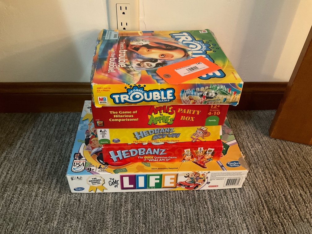 Boxed board games including Life & Trouble - Basement Living & Bar Area