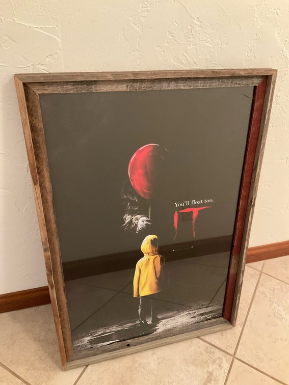 Warner Bros. IT movie poster in rustic wood frame - Basement Living & Bar Area