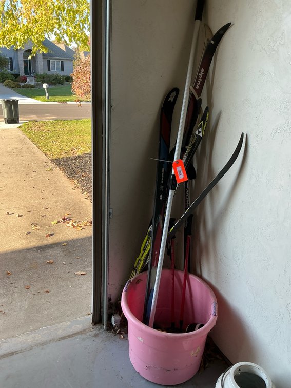 Assorted cross-country skis, poles & boots with tub - Garage
