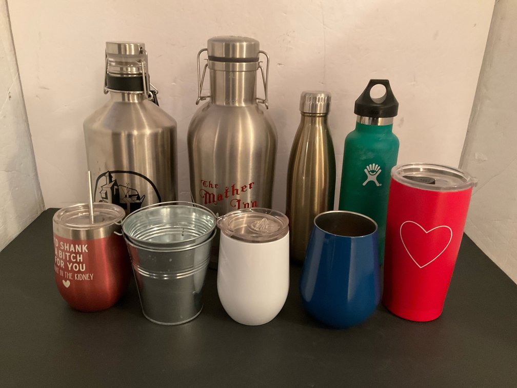 Grouping of insulated drinkware & stainless growlers - Basement Living & Bar Area