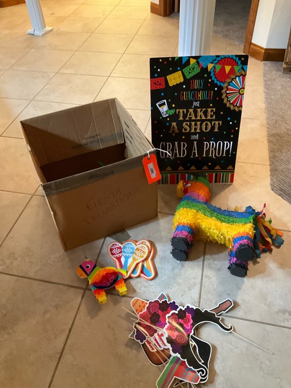 Fiesta party decorations with piñata & photo booth props - Basement Living & Bar Area