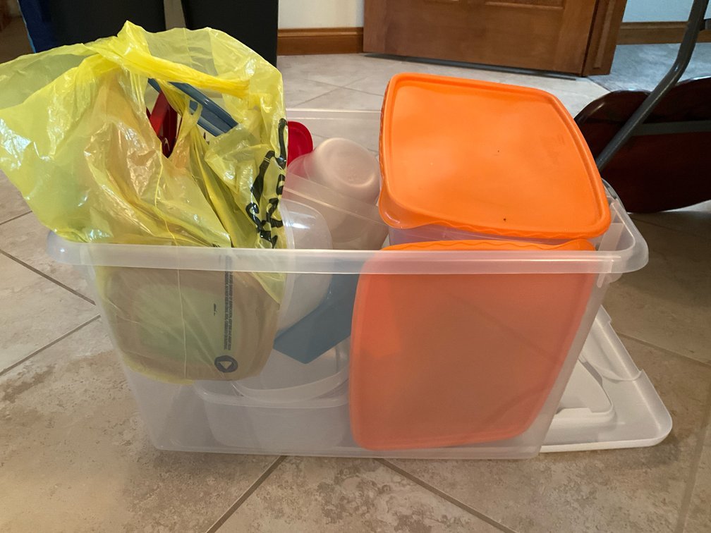 Plastic food storage containers & lids in storage tote - Basement Living & Bar Area
