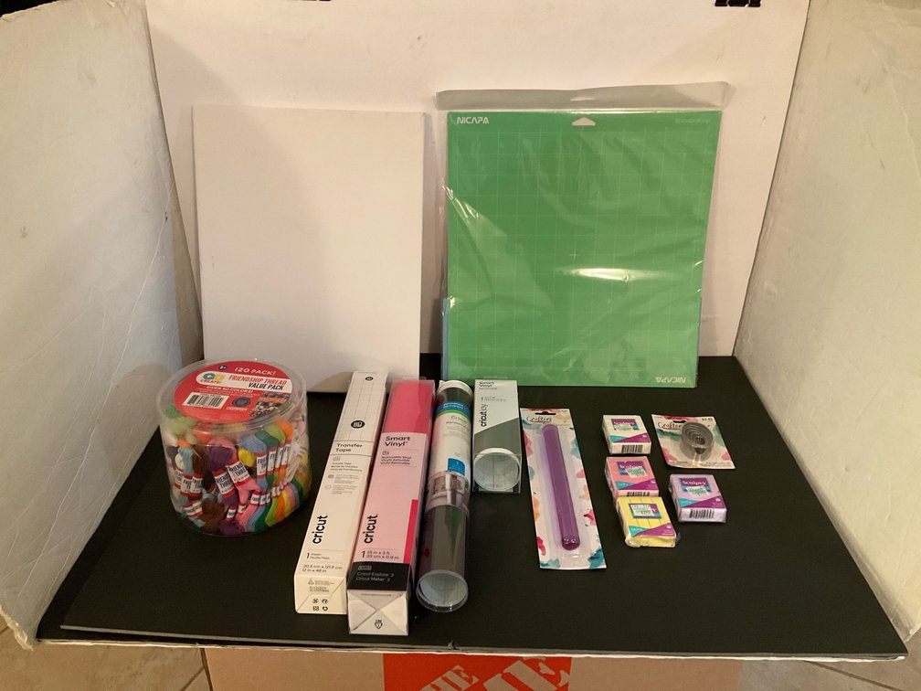 Assorted craft supplies with vinyl, cutting mats & canvas - Basement Living & Bar Area