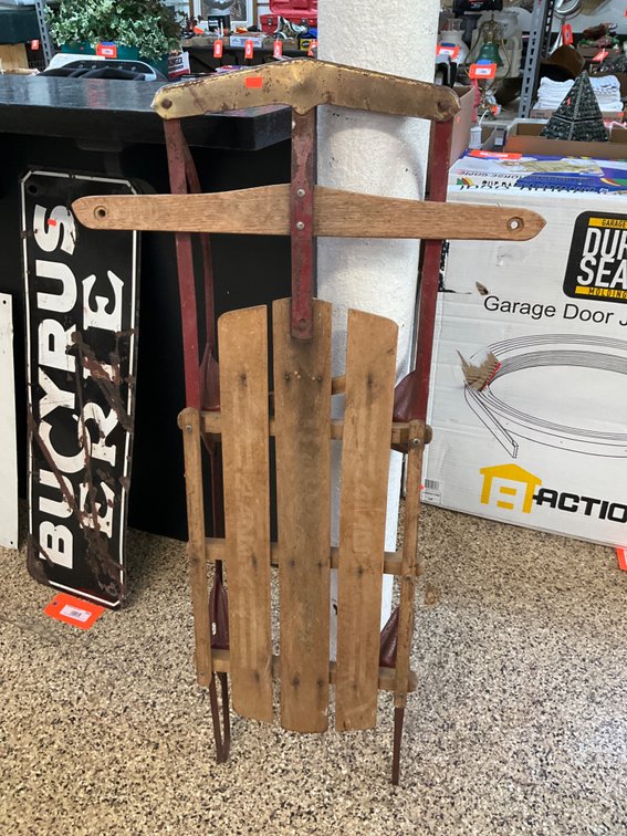 Wooden snow sled with red metal runners