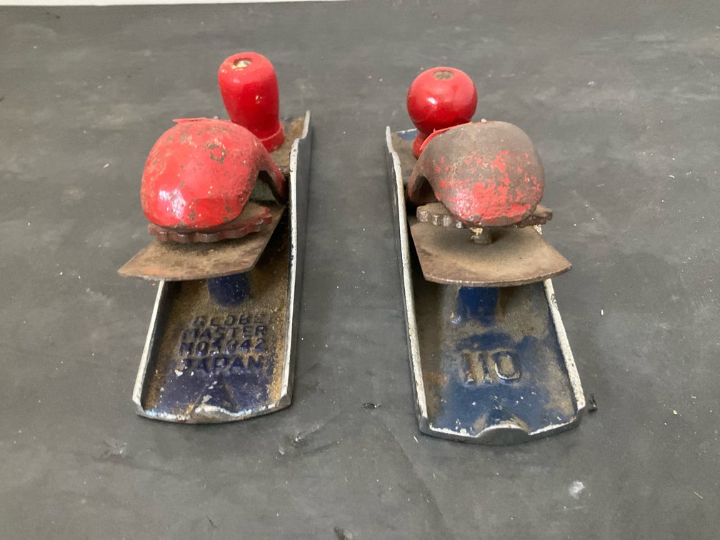 Pair of hand block planes with red lever caps
