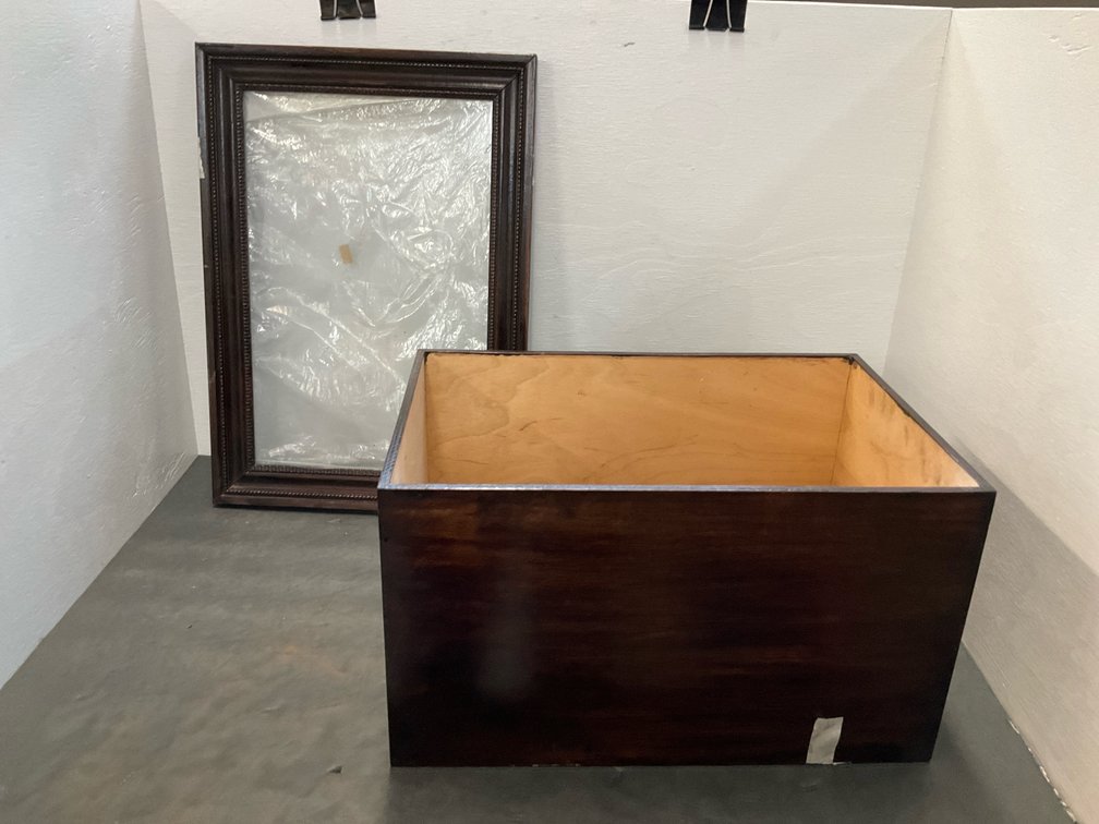 Dark wood display case with framed glass top