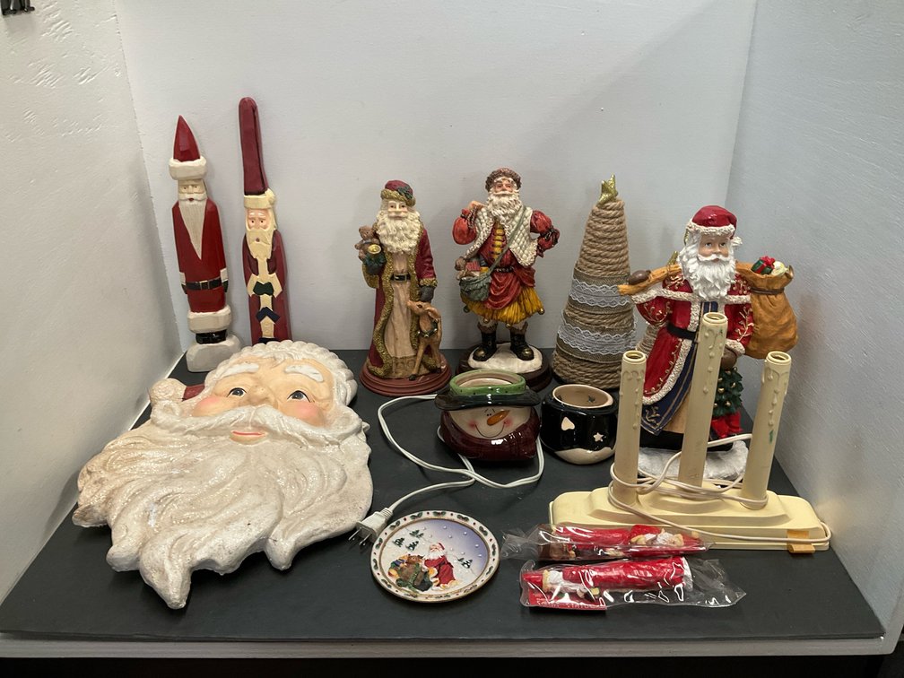 Assorted Christmas holiday decor with Santa figurines