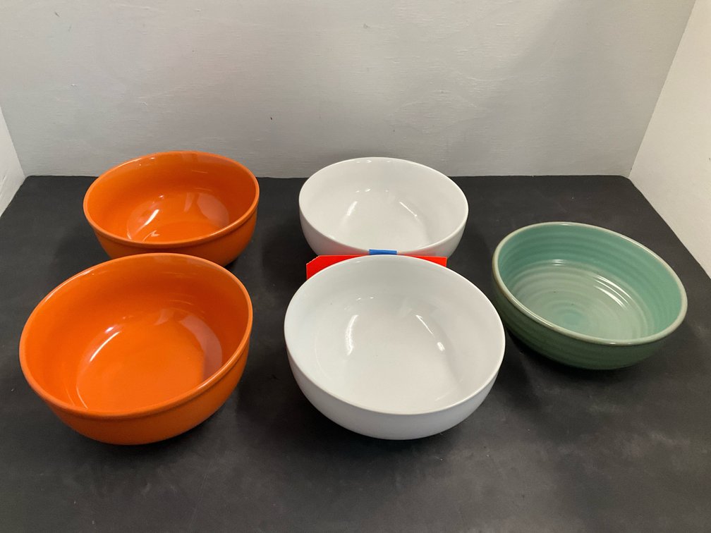 Grouping of ceramic bowls in orange, white & green