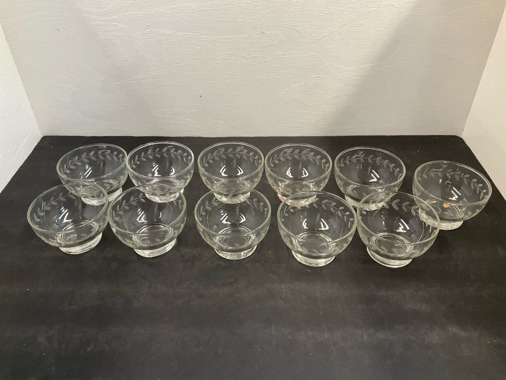 Group of clear glass footed bowls with etched leaf band