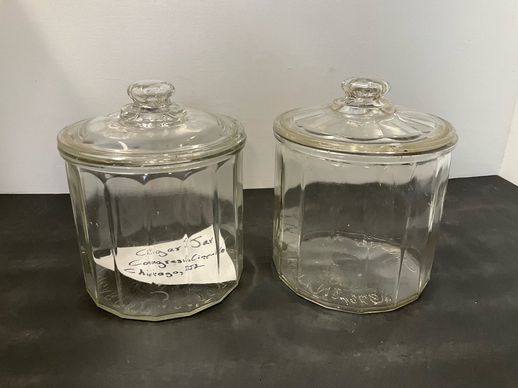 Pair of clear glass paneled cigar jars with lids