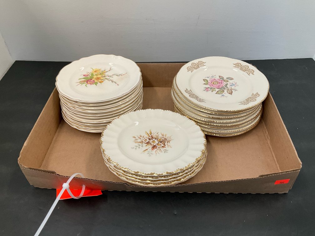 Grouping of floral china plates with gold trim