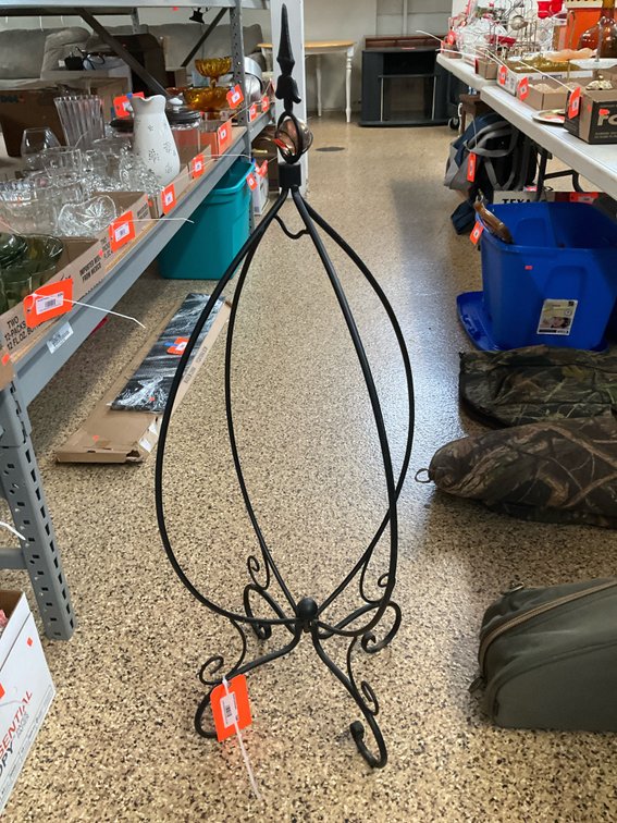 Black wrought metal hanging display stand with orb finial