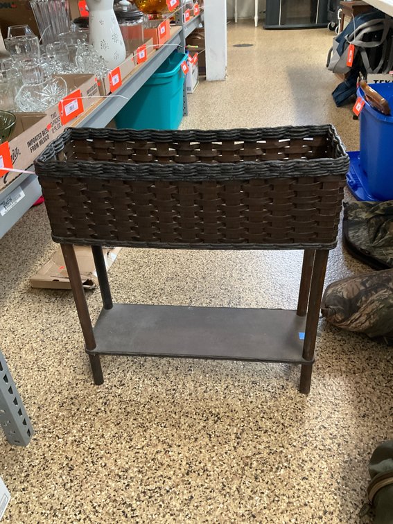 Dark brown woven planter stand with lower shelf