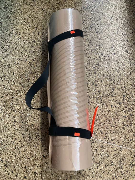 Tan foam exercise mat with carrying strap