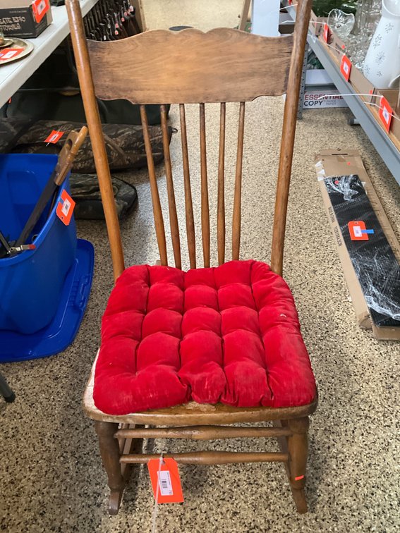 Wooden rocking chair with red tufted cushion