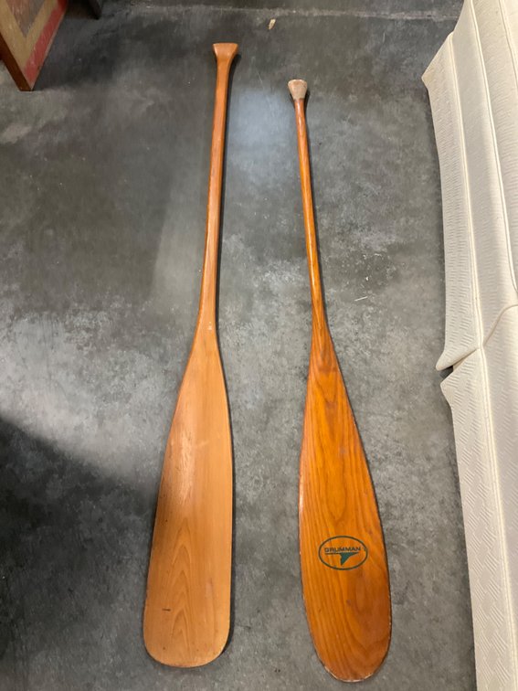 Pair of wooden canoe paddles of differing lengths