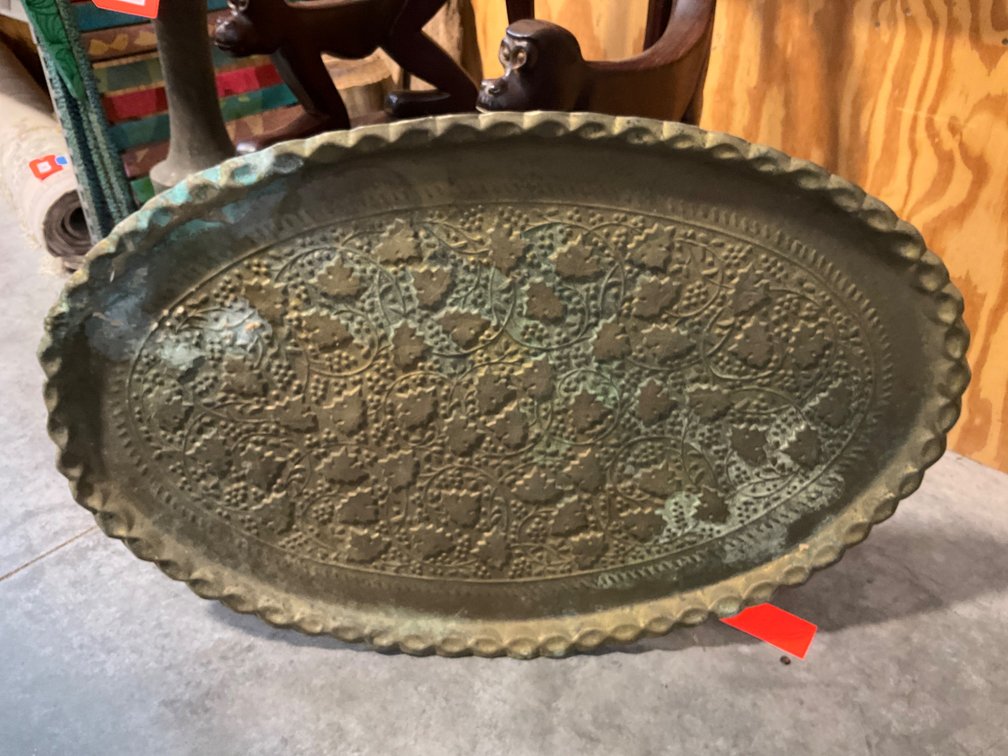 Oval embossed brass tray with scalloped rim