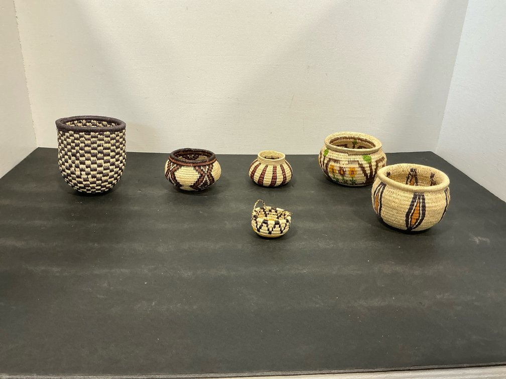 Grouping of hand-woven coiled fiber baskets