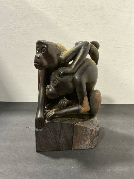 Carved wood monkey sculpture on block base