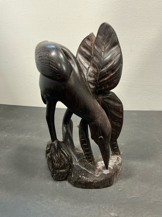 Hand-carved dark wood wading bird sculpture