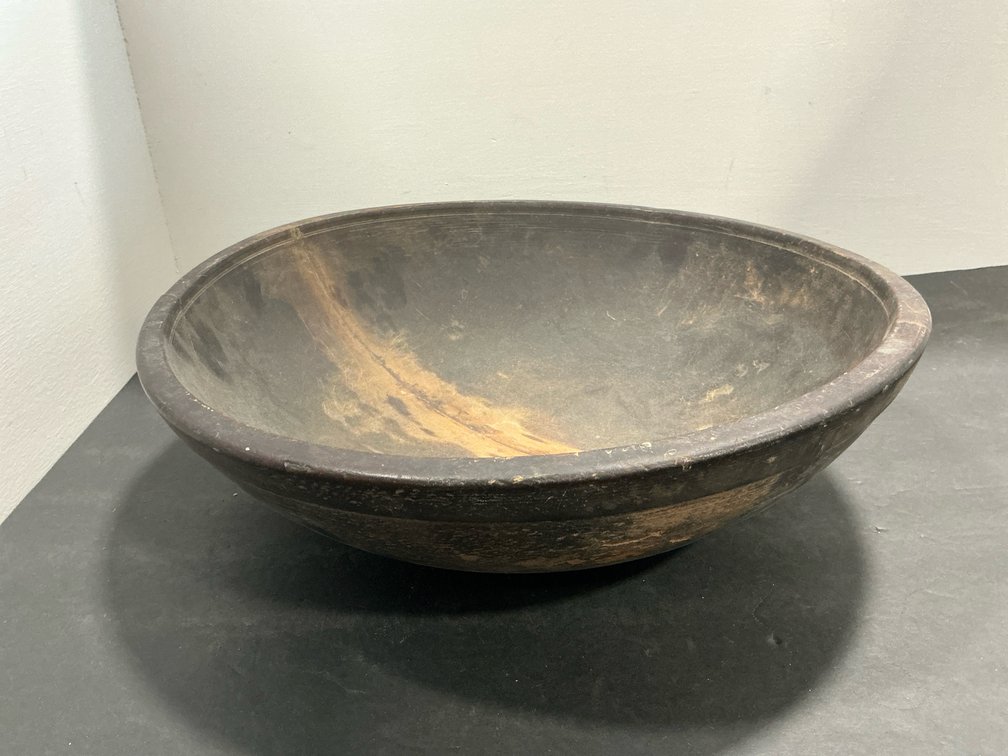 Turned dark wood bowl with incised rim