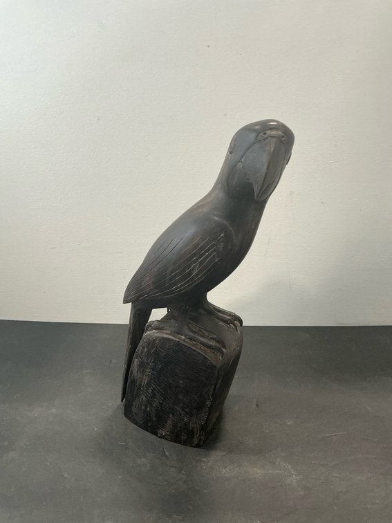 Carved dark wood parrot sculpture on block base