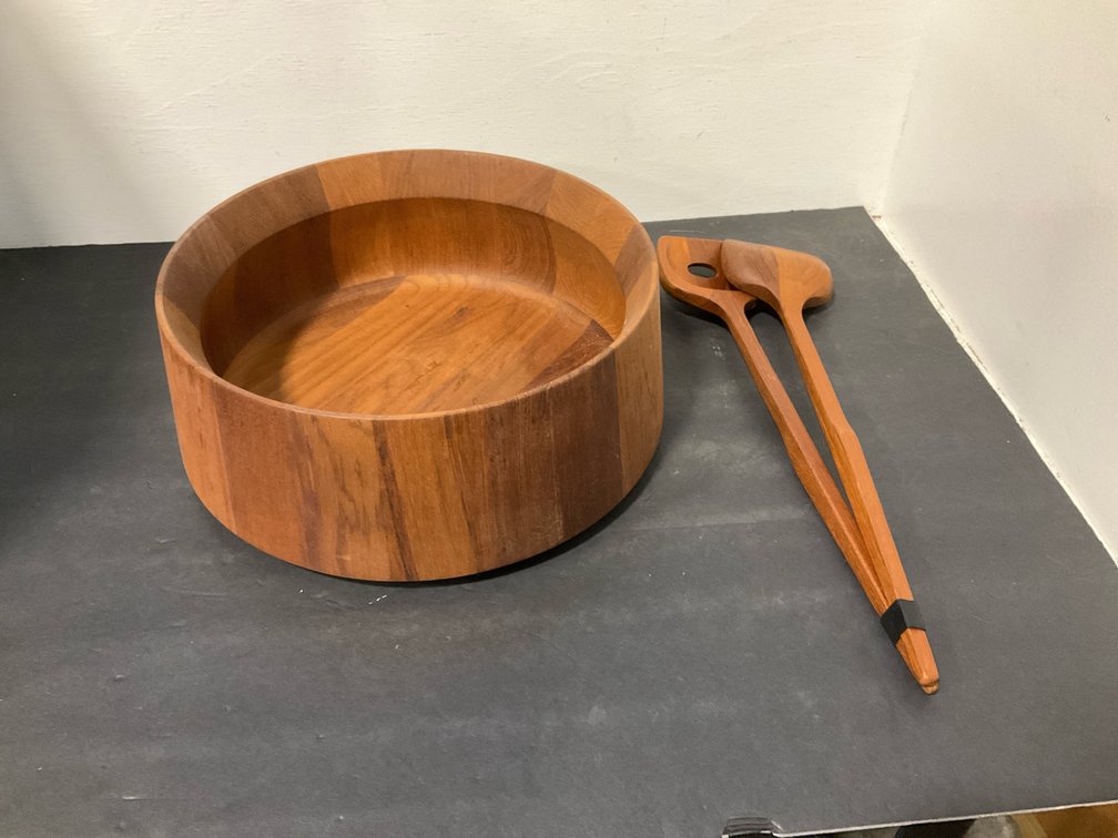 Wooden salad bowl with serving utensils