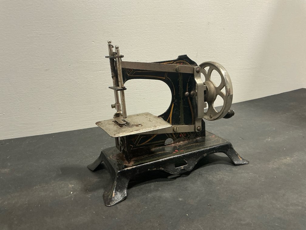 Miniature cast iron hand-crank sewing machine