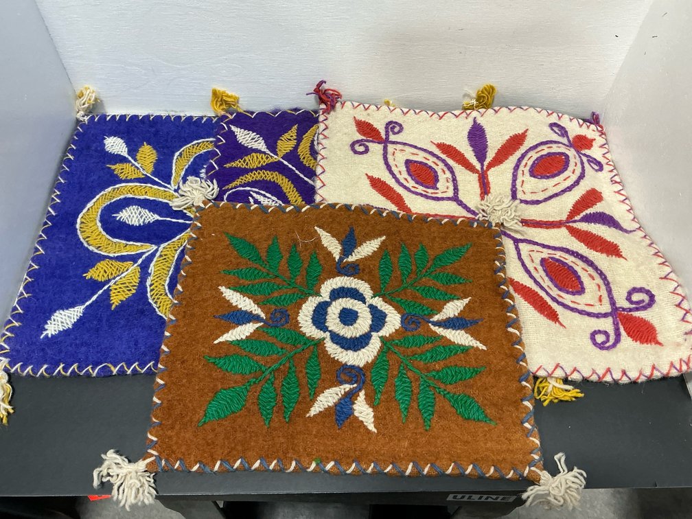 Embroidered felt mats with tassels