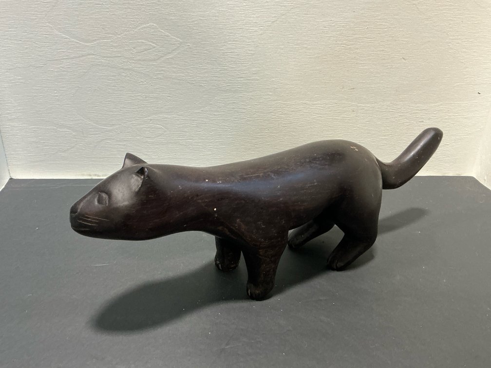 Carved dark wood stylized cat figurine