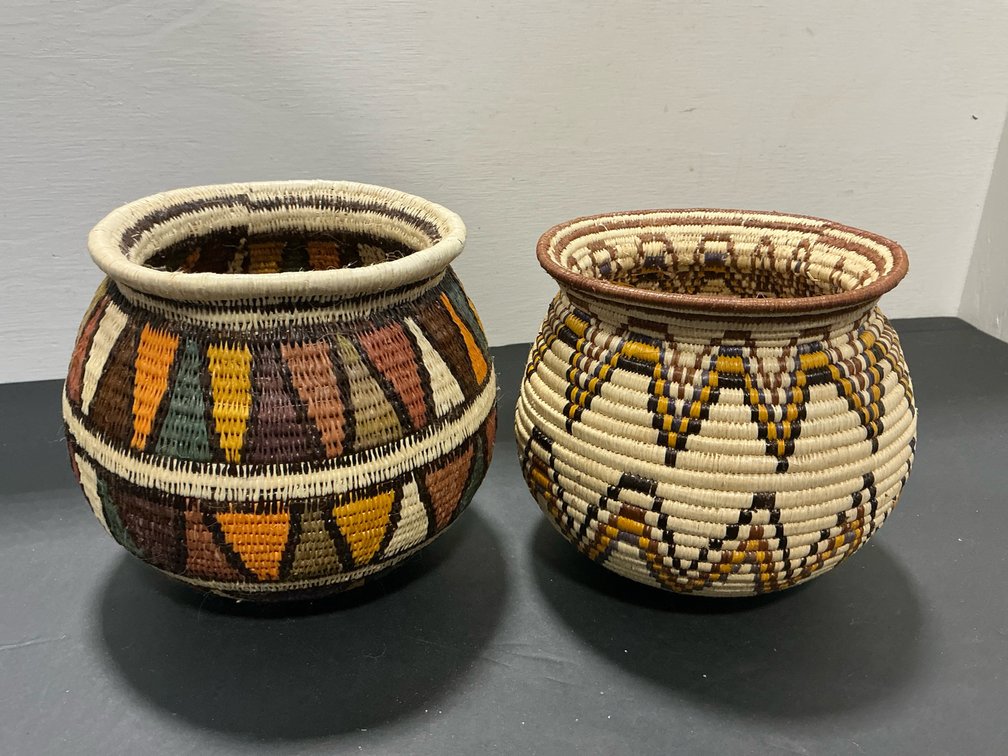 Pair of coiled woven baskets with geometric patterns