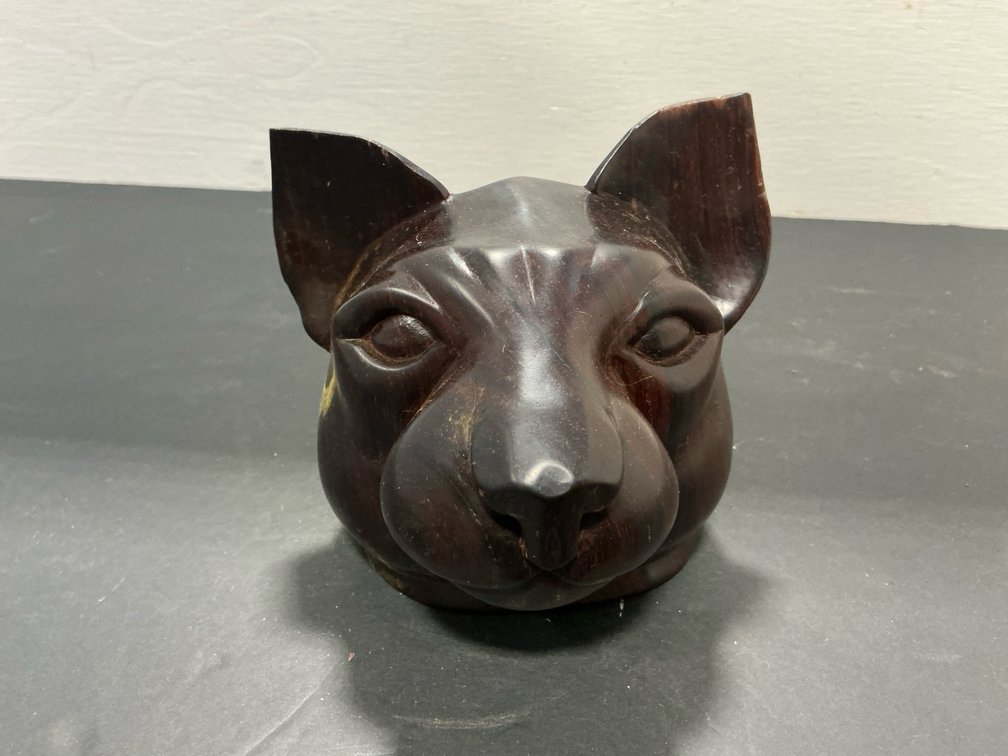 Carved dark wood feline head sculpture