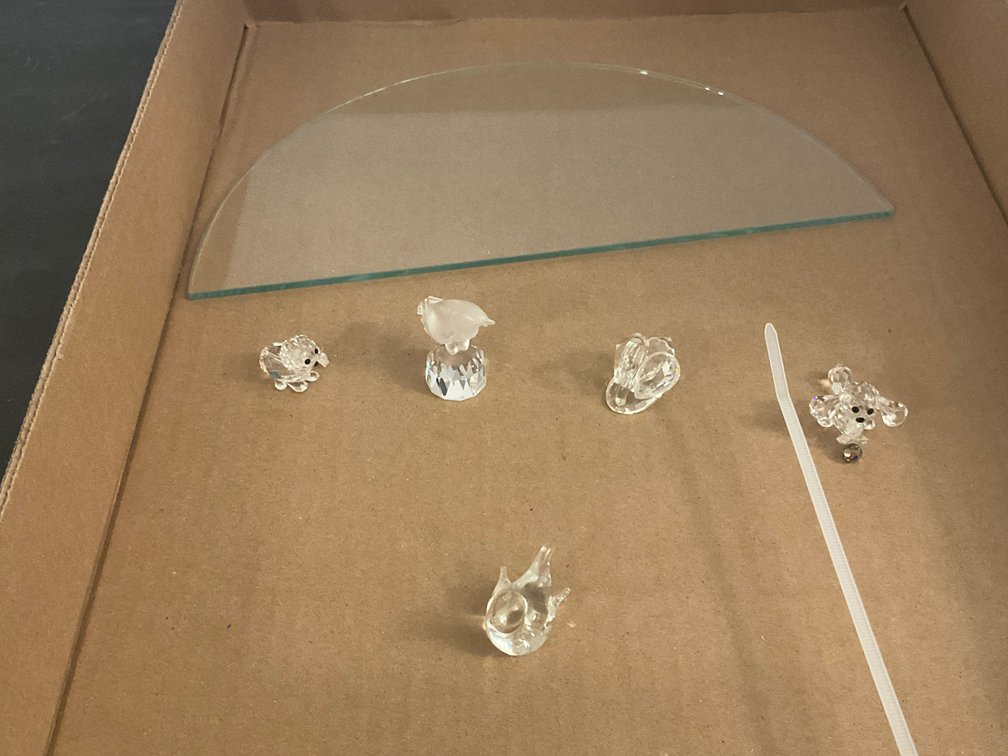 Crystal animal figurines & semicircular glass shelf - Dining Room Main Level